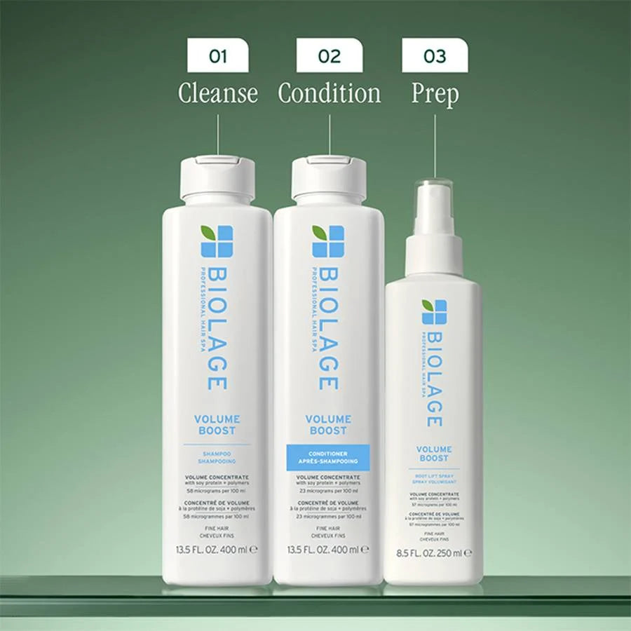 Three BIOLAGE Volume Boost hair care products on a green background