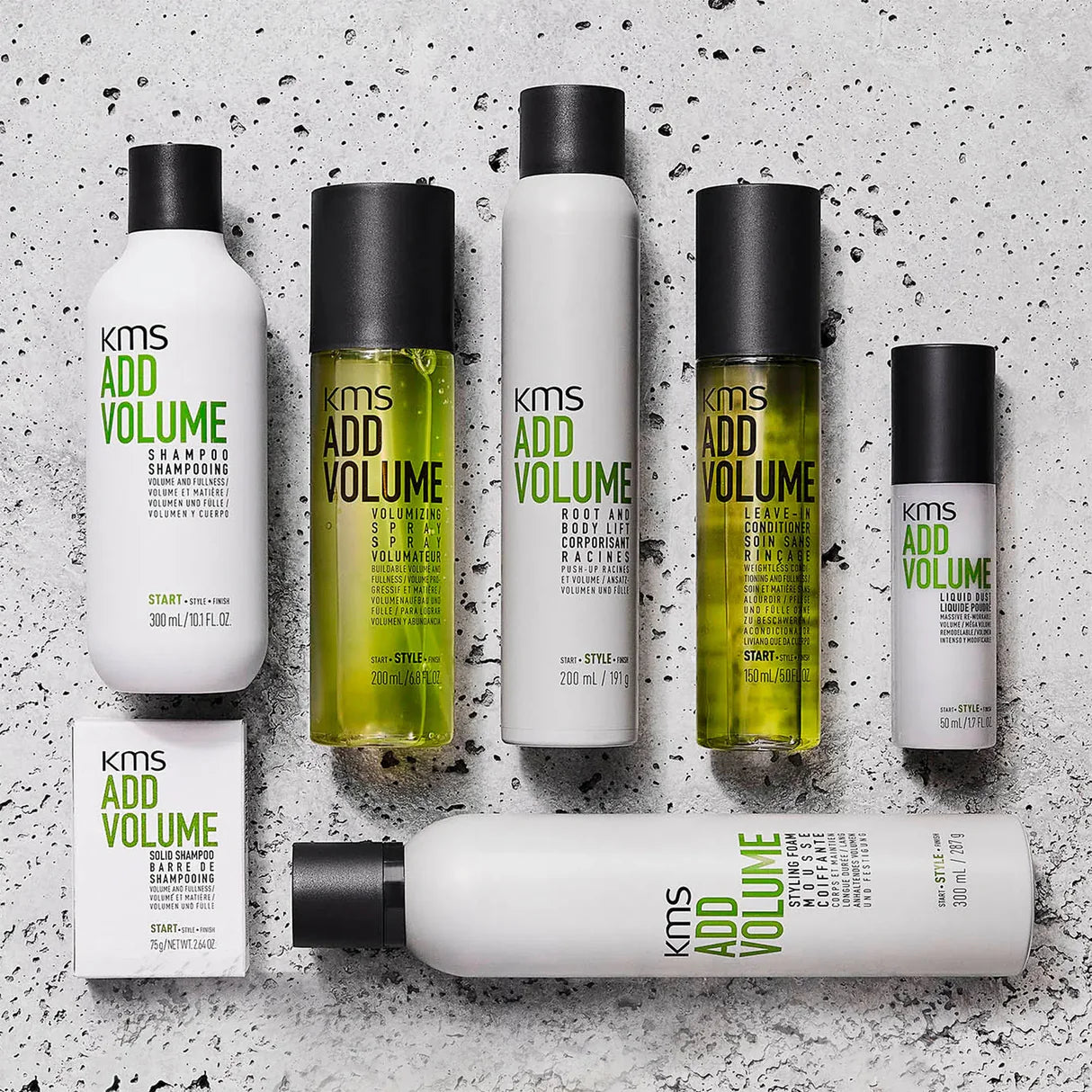 KMS Add Volume hair care products on a textured gray background