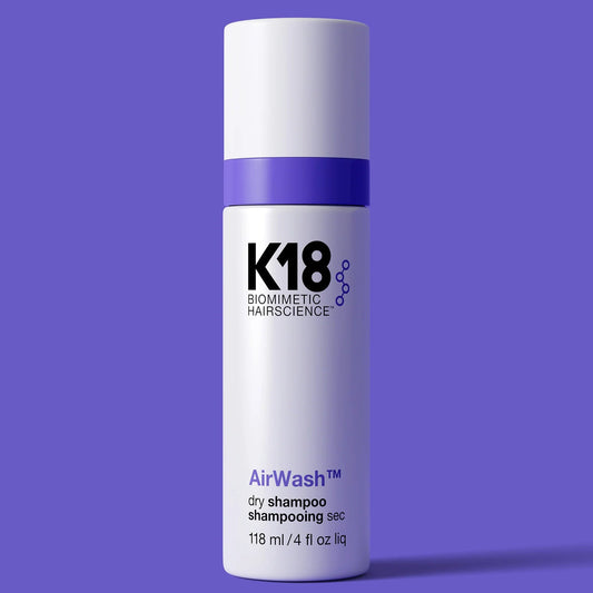 K18 AirWash dry shampoo bottle on a purple background
