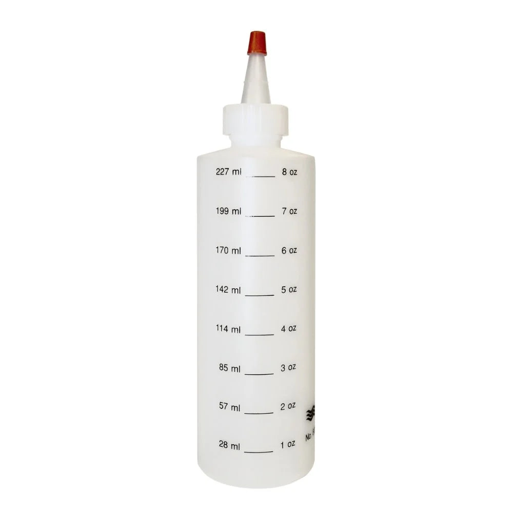 A white plastic squeeze bottle with a red cap and black printed measurement markings in milliliters and ounces, shown on a plain white background.