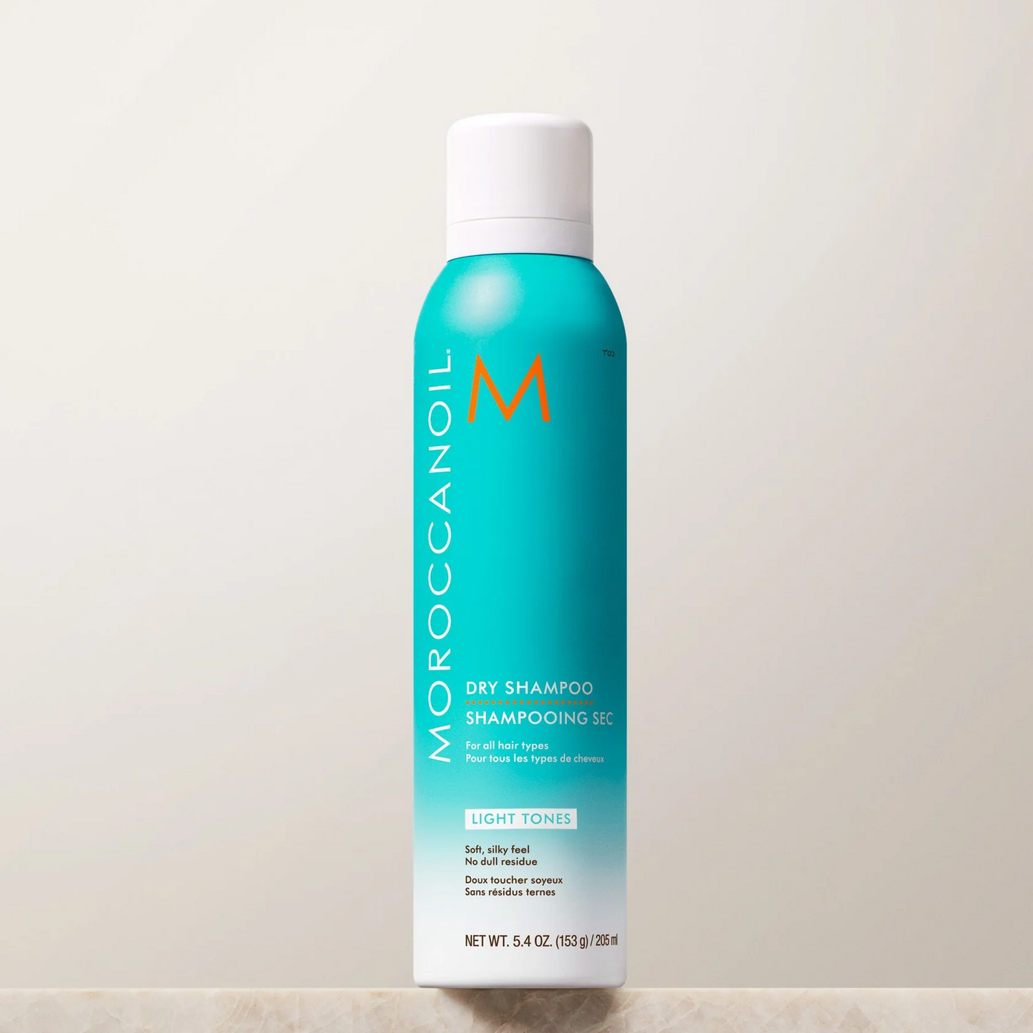 Moroccanoil dry shampoo can on a light background
