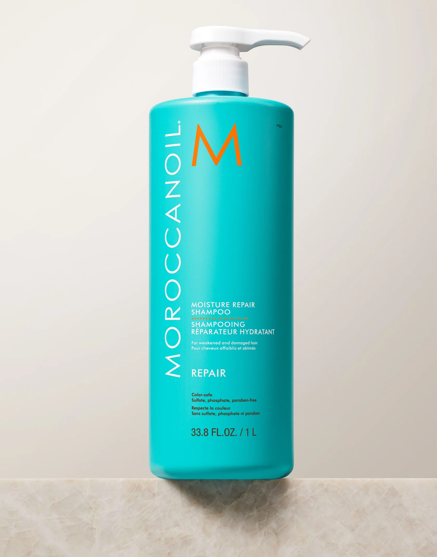 Moroccanoil shampoo bottle on a tiled bathroom wall