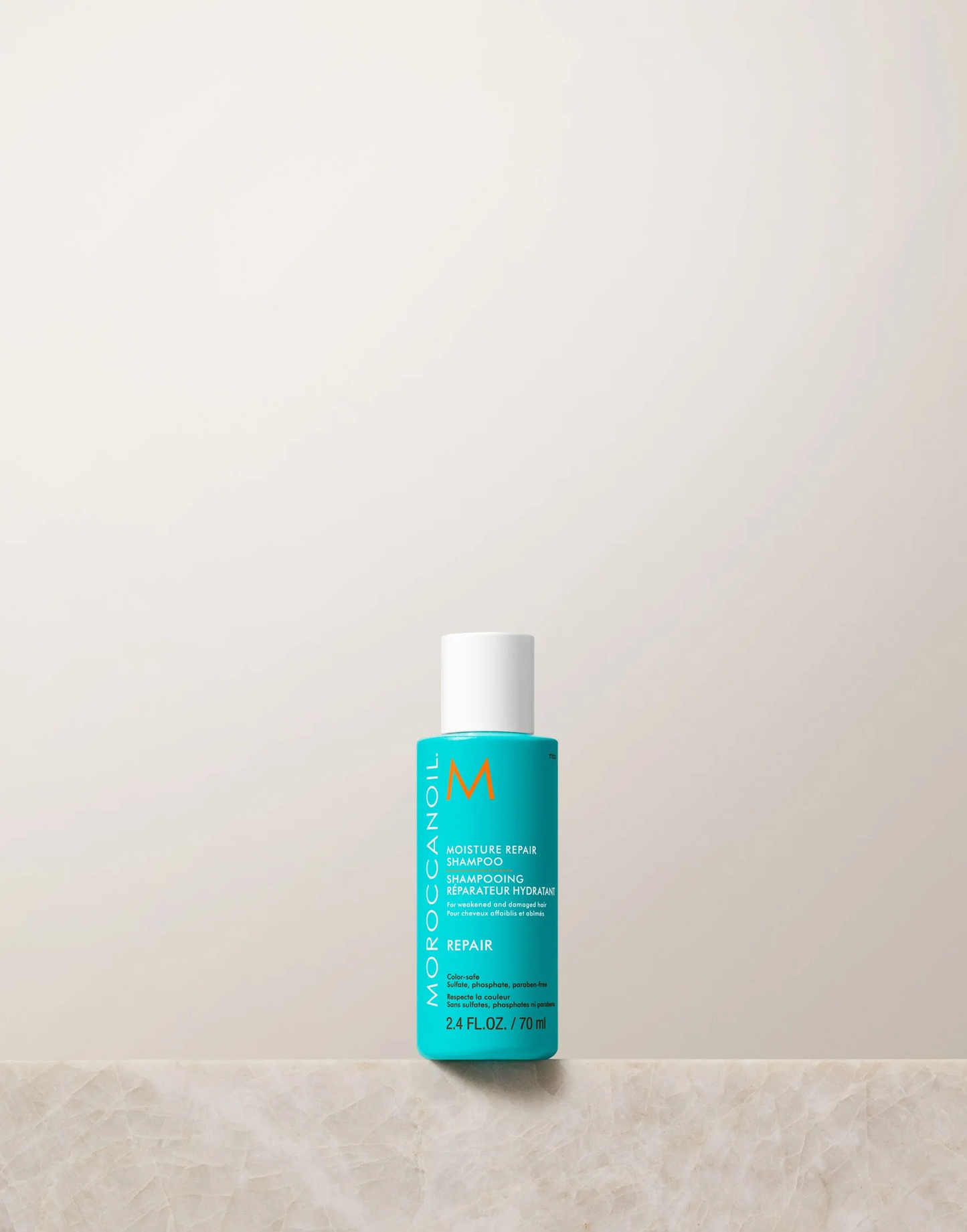 Blue bottle with white cap on a beige surface