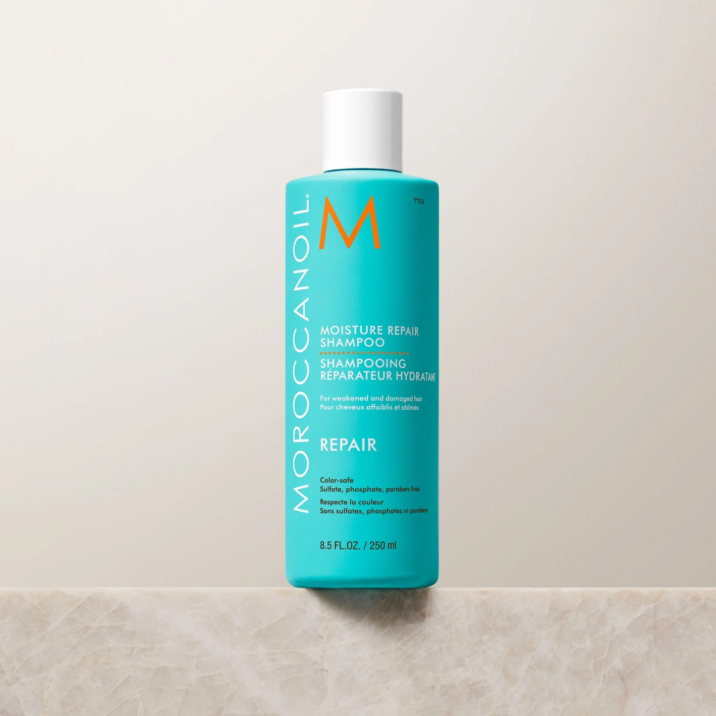Moroccanoil shampoo bottle on a light beige background