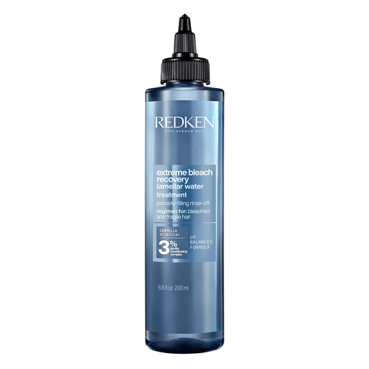 Redken bottle of extreme bleach recovery treatment on a white background