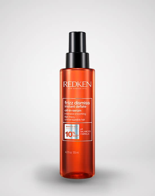 Redken hair care product bottle on a light gray background