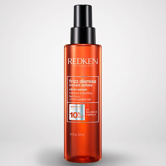 Redken hair care product bottle on a light gray background