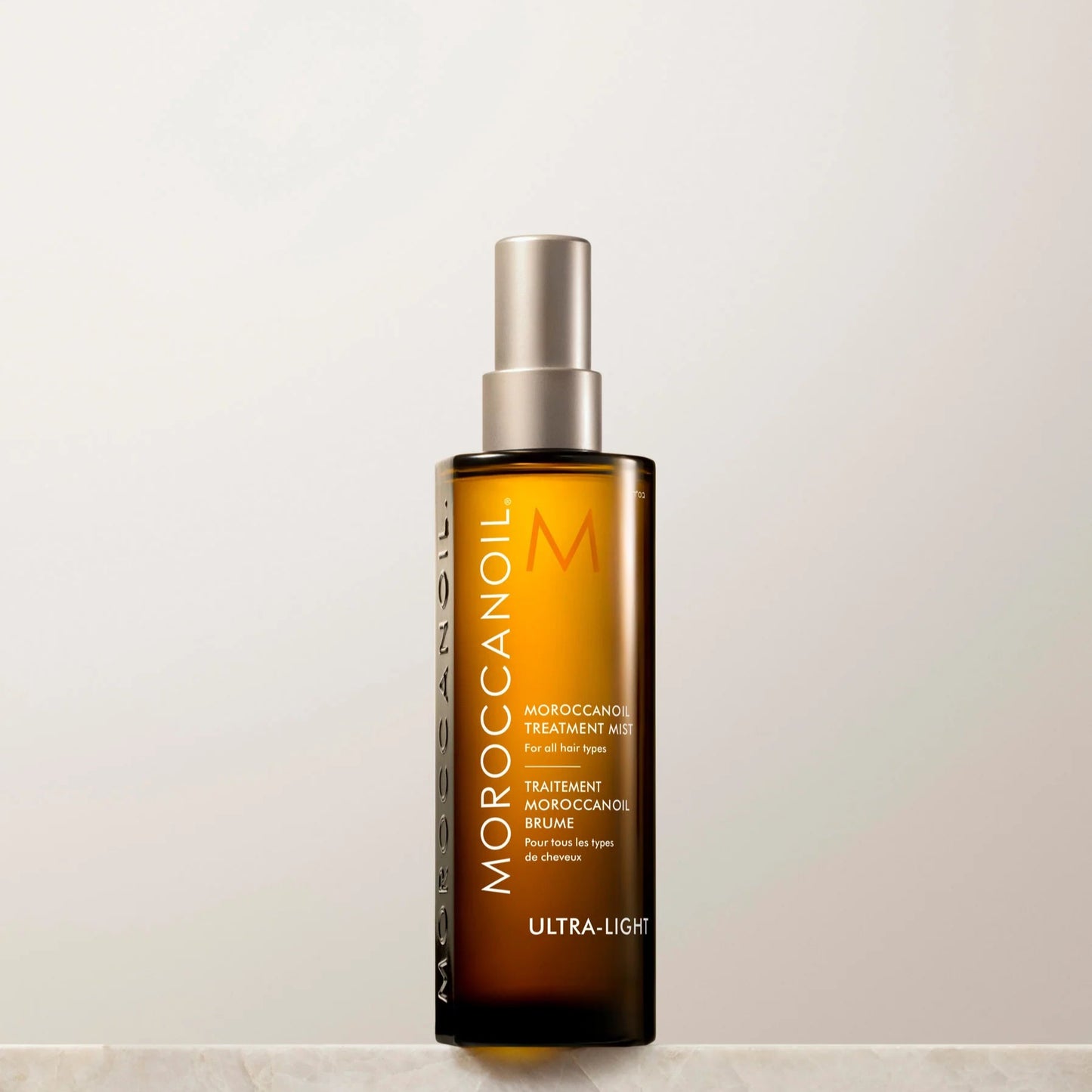 Moroccanoil hair treatment bottle on a light background