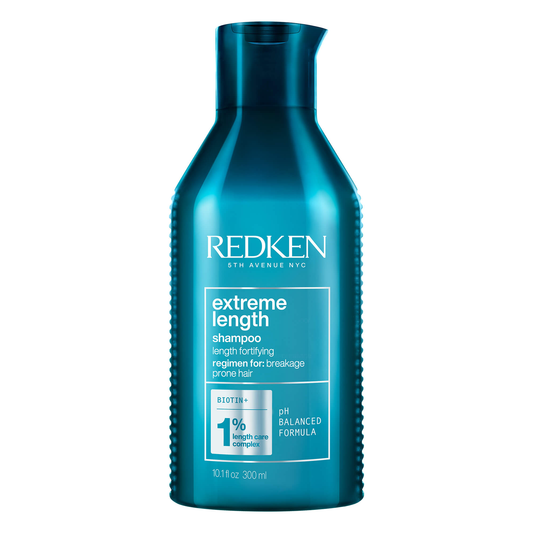 Blue bottle of Redken Extreme Length shampoo on a white background