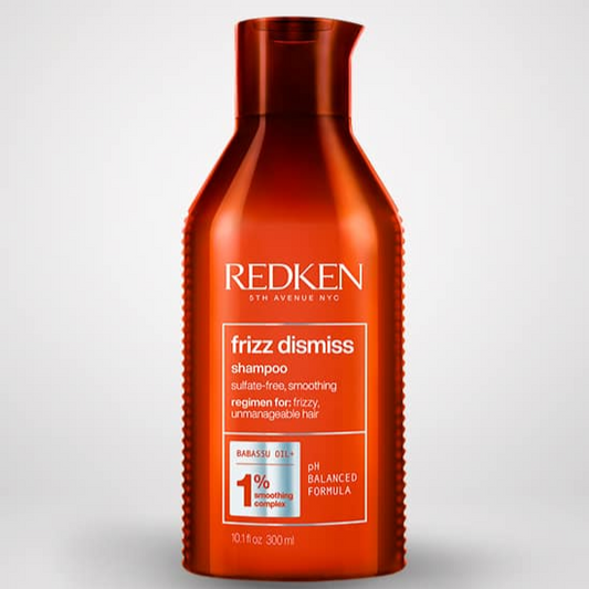 Redken frizz dismiss shampoo bottle on a light gray background