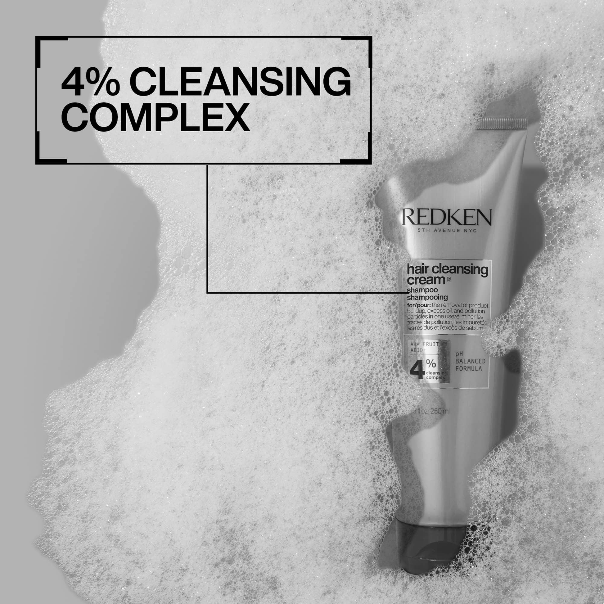 Redken hair cleansing cream with 4% cleansing complex on a textured background