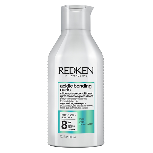 Redken bottle of acidic bonding curls conditioner on a white background