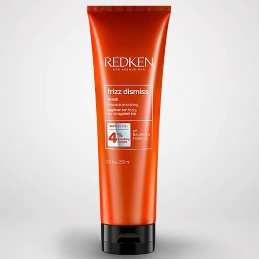 Redken frizz dismiss hair product tube on a white background