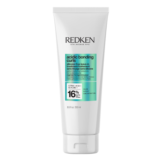 Redken hair care product tube on a white background