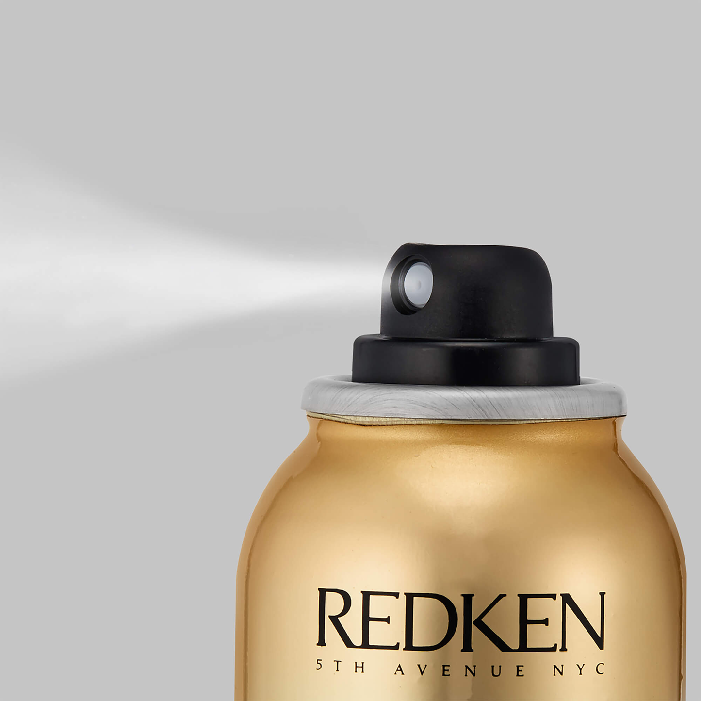 Redken hair spray can on a gray background