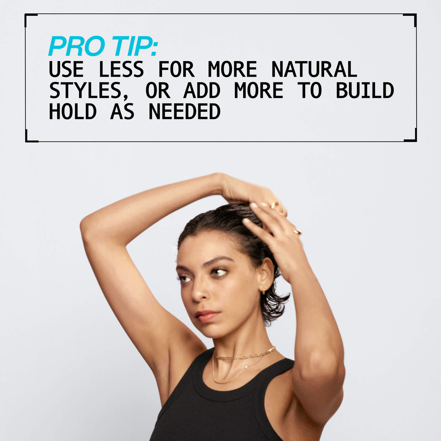 Woman styling her hair with text overlay on a light gray background