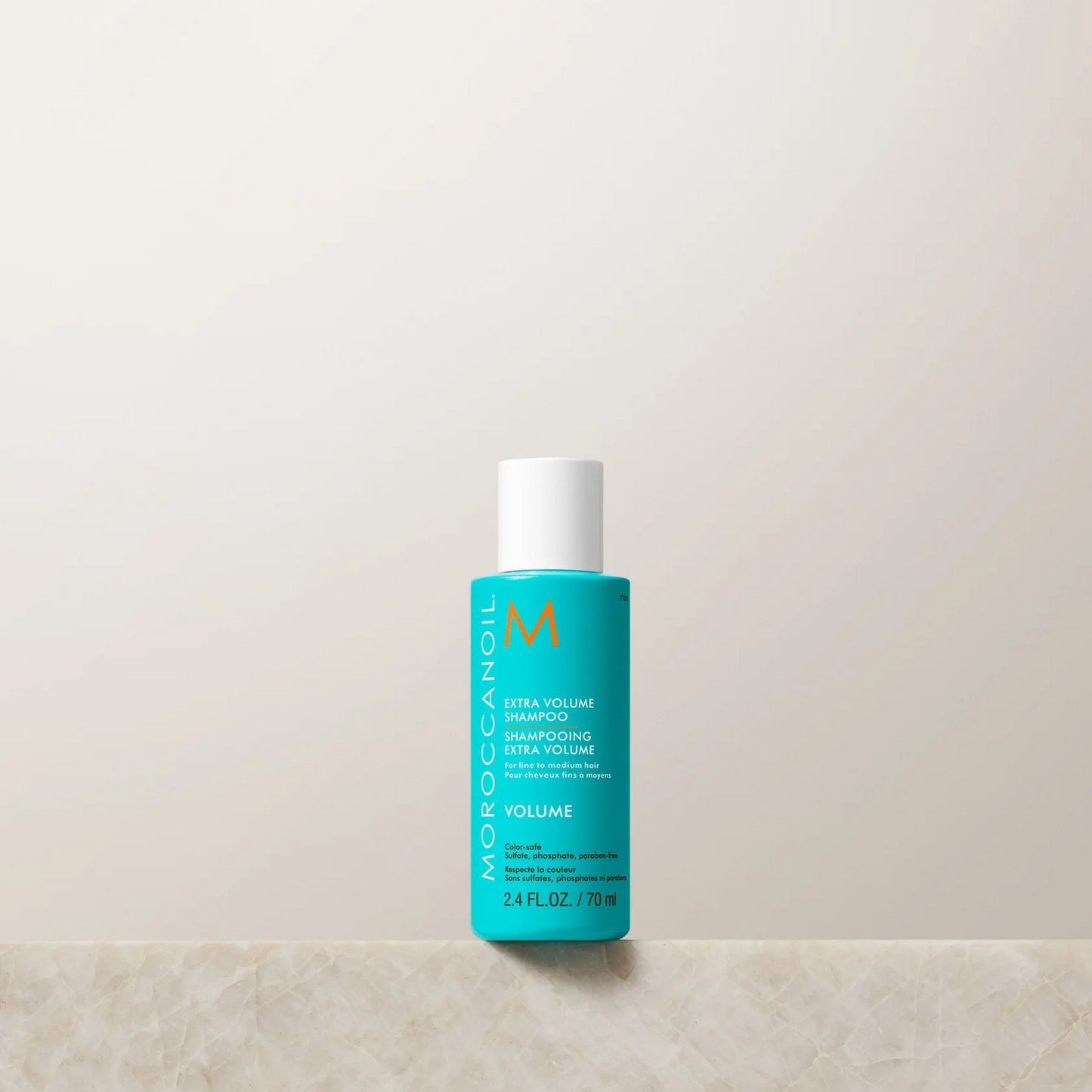 Moroccanoil bottle on a light beige background