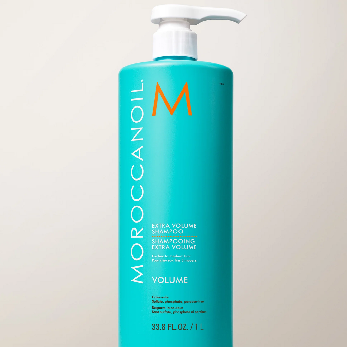 Moroccanoil shampoo bottle on a tiled bathroom wall