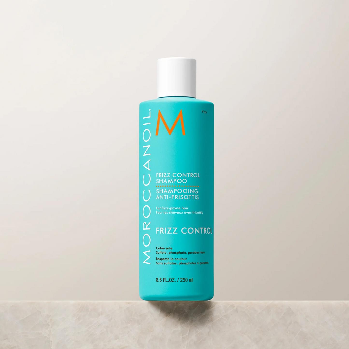 Moroccanoil frizz control shampoo bottle on a light background
