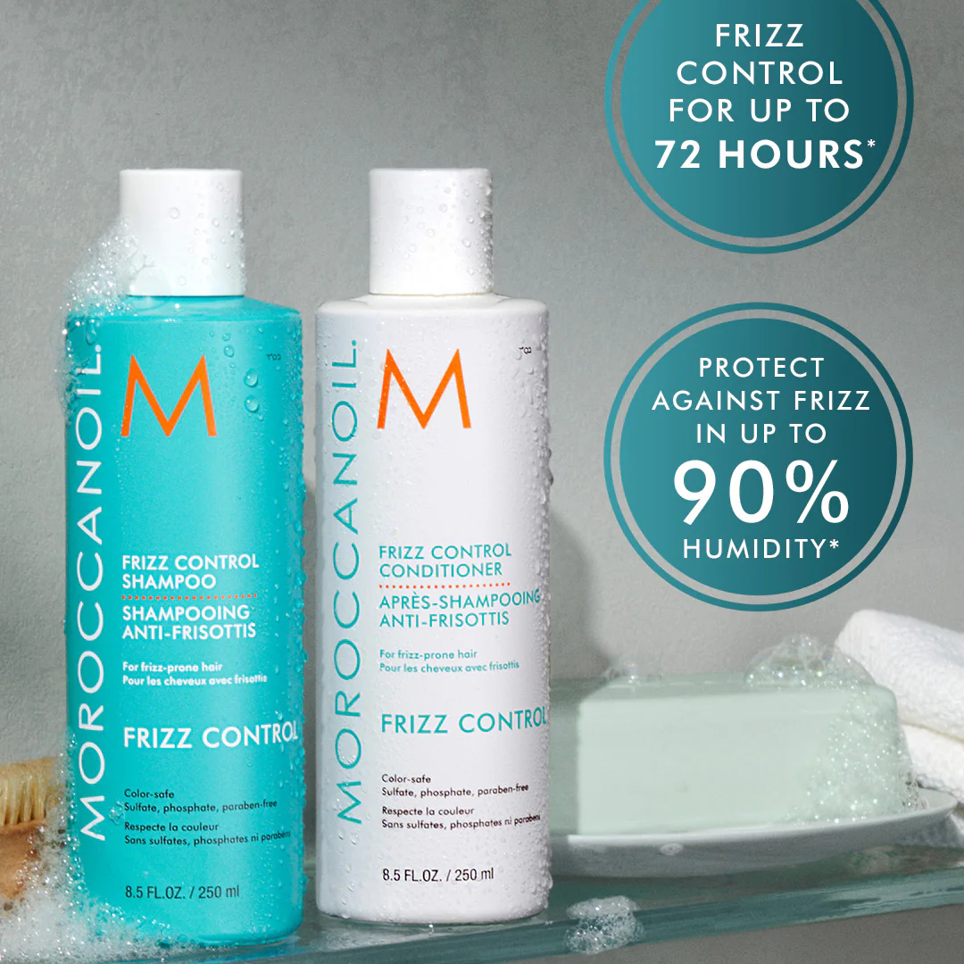 Moroccanoil frizz control shampoo and conditioner bottles on a gray background