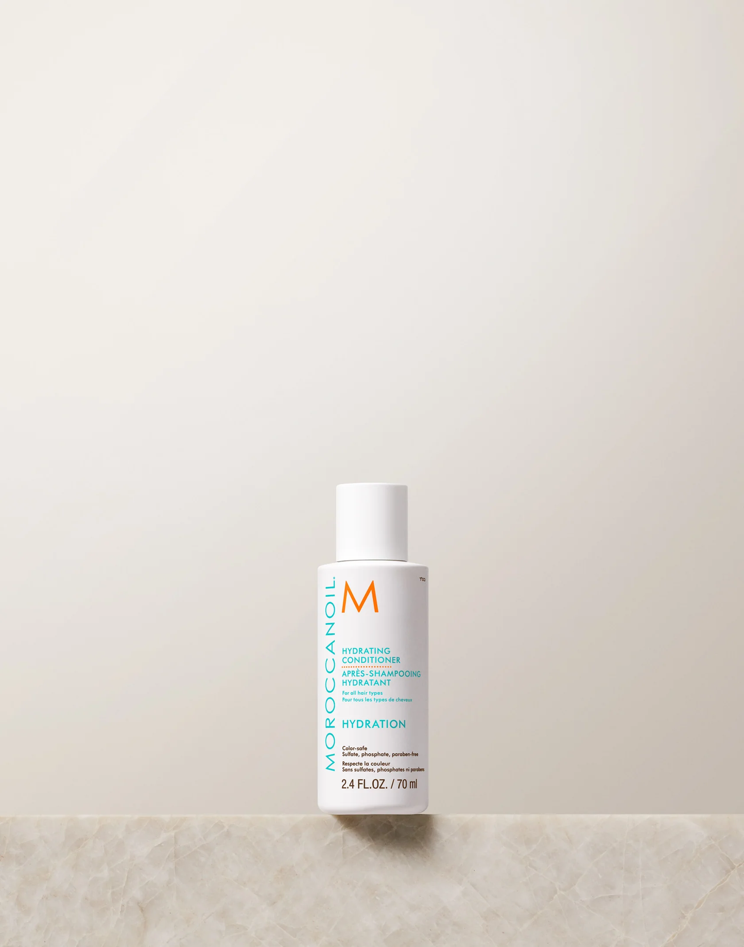 Moroccanoil bottle on a light beige background