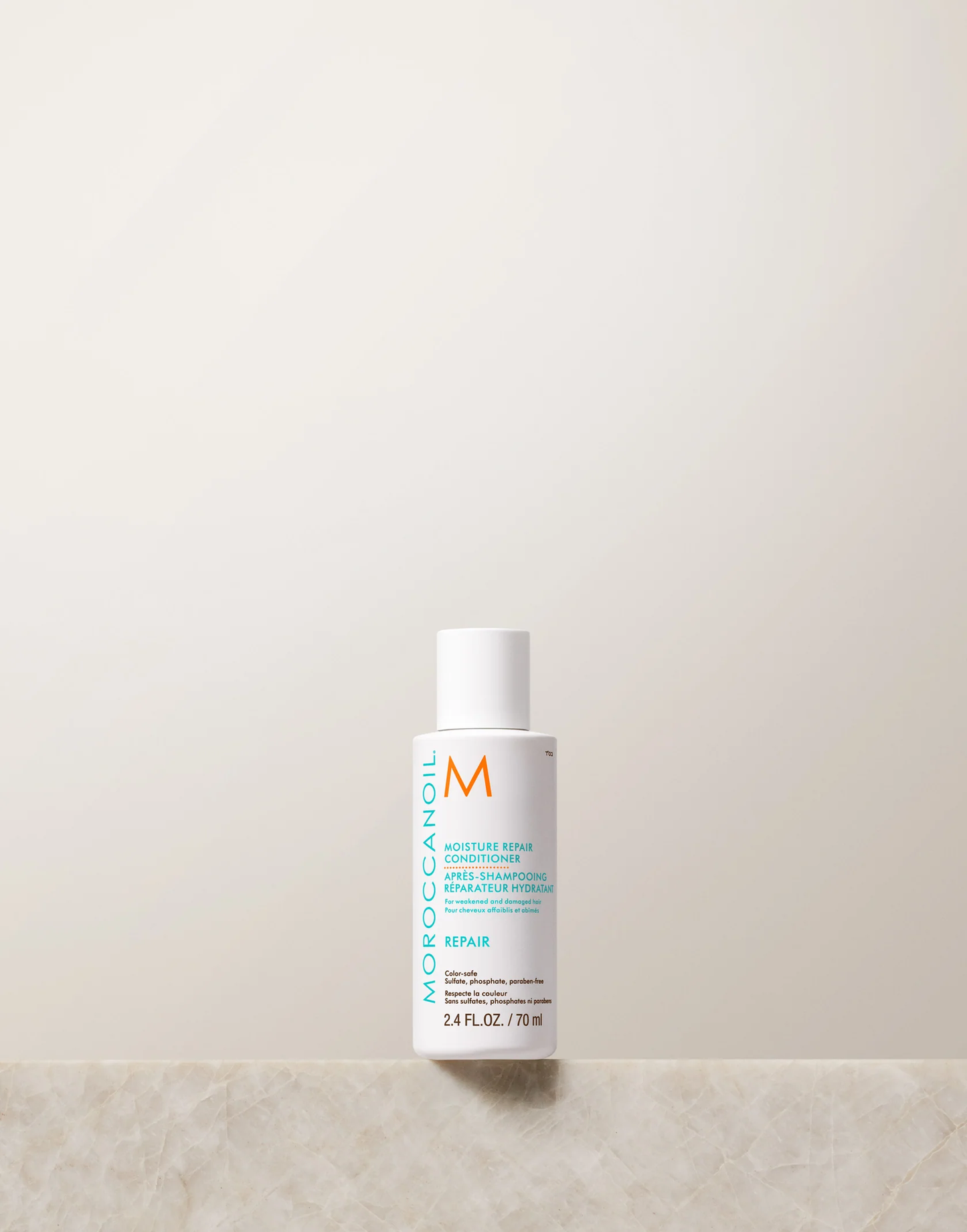 Moroccanoil bottle on a light beige background