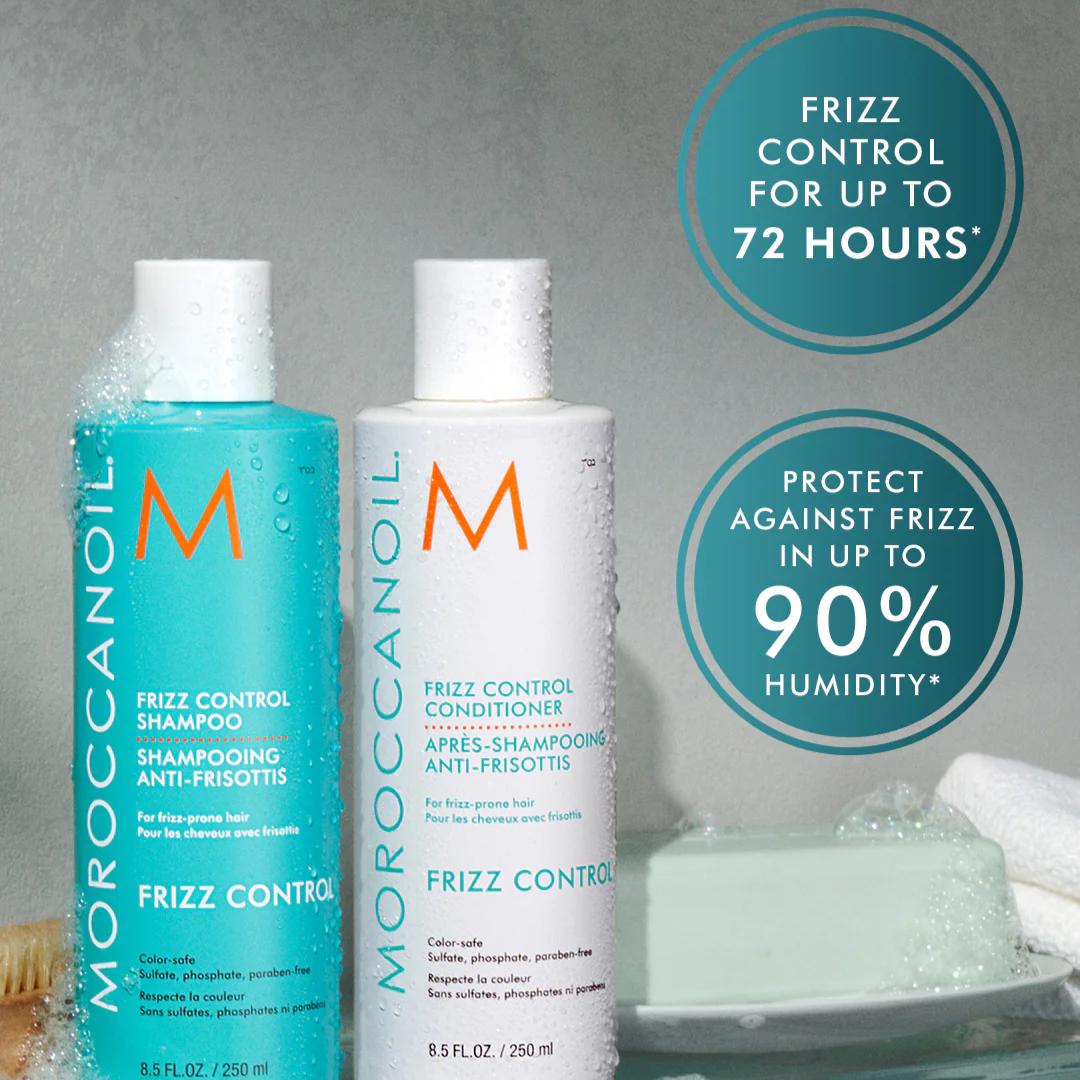 Moroccanoil frizz control shampoo and conditioner bottles on a gray background