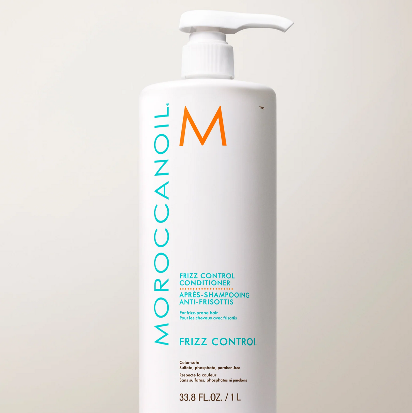 Moroccanoil frizz control product bottle on a light background
