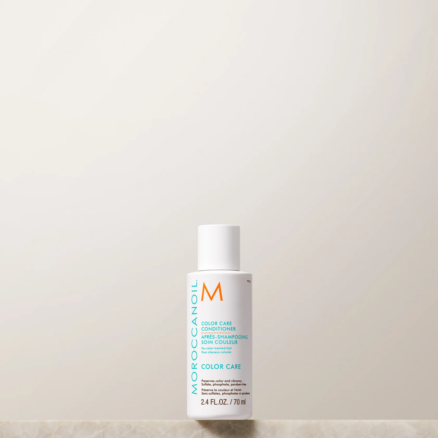 Moroccanoil bottle on a light beige background