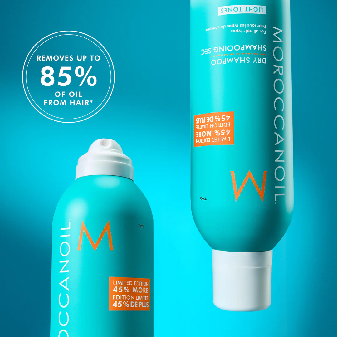 Moroccanoil dry shampoo and shampoo bottles on a blue background