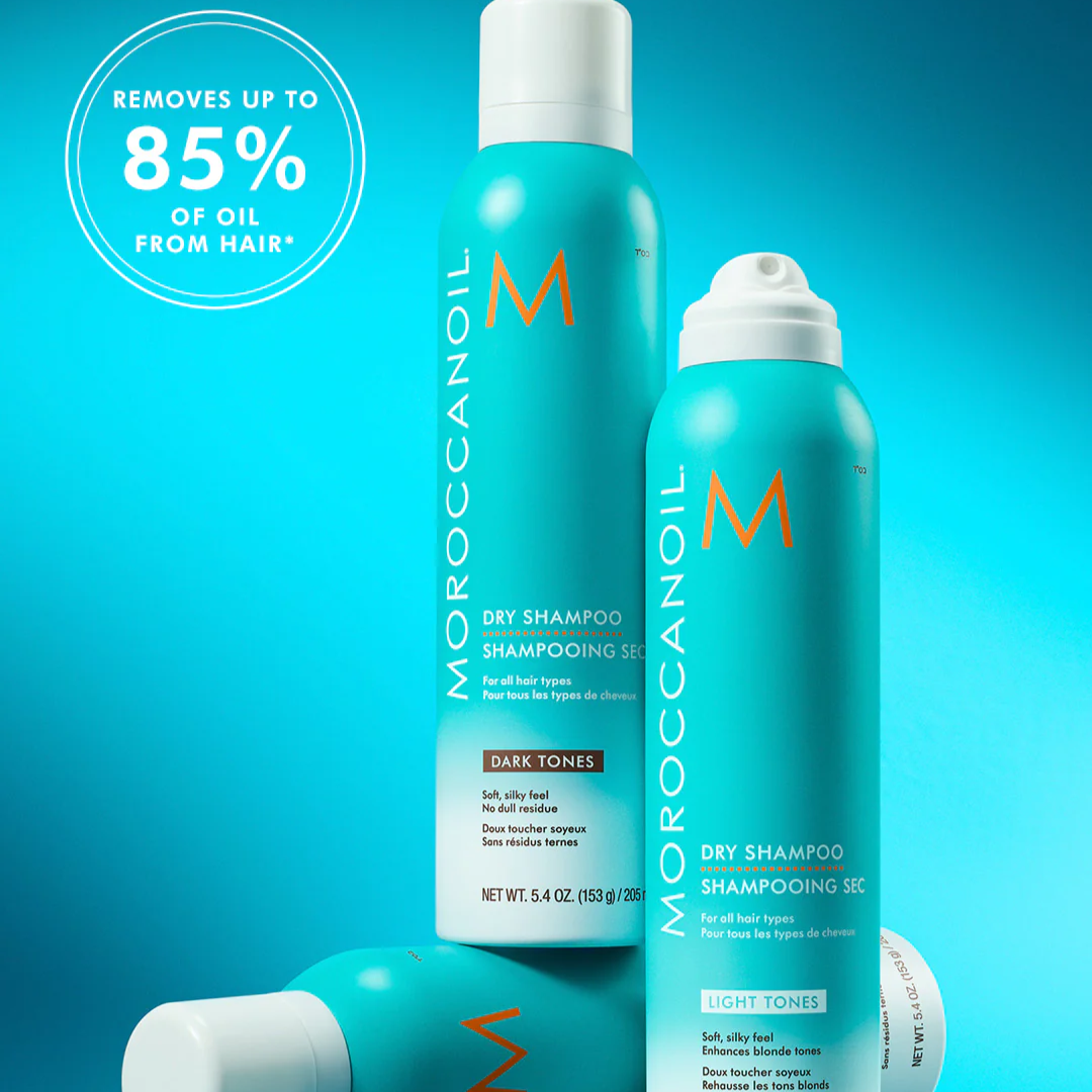 Moroccanoil dry shampoo bottles on a blue background