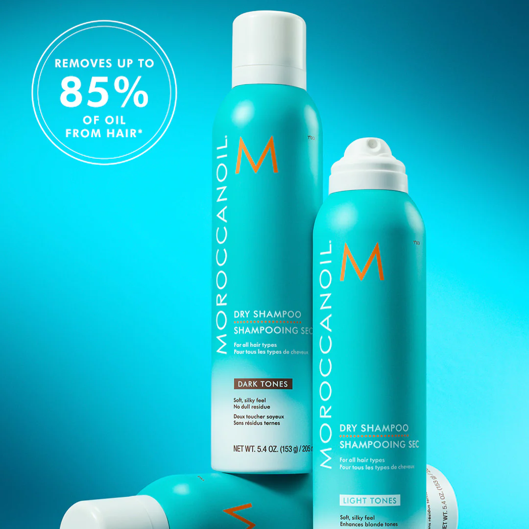 Moroccanoil dry shampoo bottles on a blue background