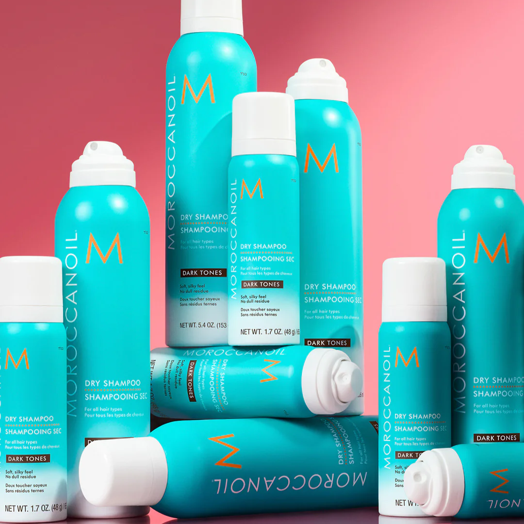 Moroccanoil dry shampoo bottles on a pink background