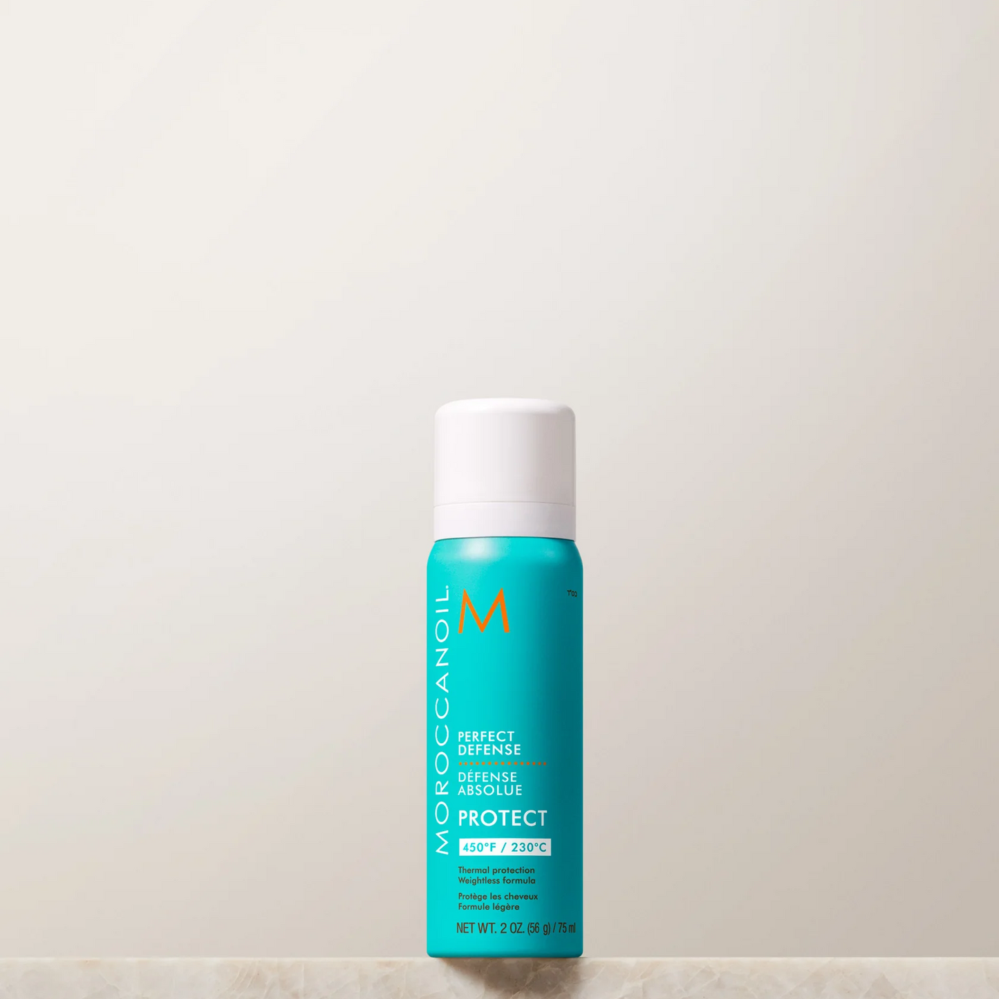 Moroccanoil bottle on a light beige background