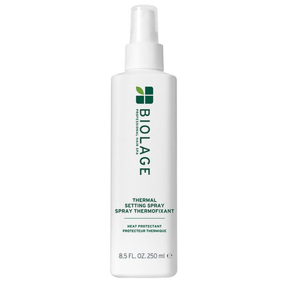 A white bottle of BIOLAGE Thermal Setting Spray Thermofixant with a white spray nozzle, featuring green text and logo on a plain white background.