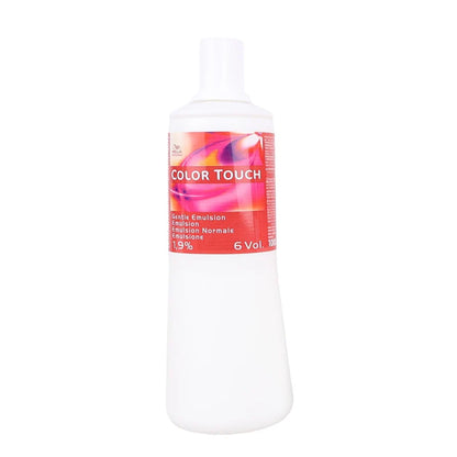 A 6 Vol color emulsion bottle with a white plastic body and cap, featuring a red and pink label with the text 'COLOR TOUCH' and '6 Vol'.