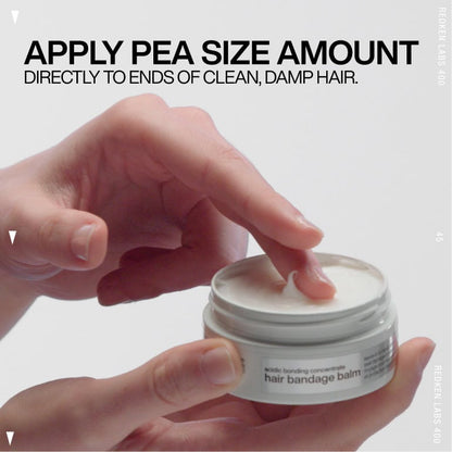 Hand applying a pea-sized amount of hair balm from a jar.