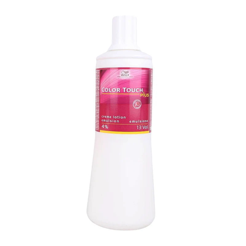 A white plastic bottle of Color Touch Plus cream lotion with a pink and yellow label, shown against a plain white background.