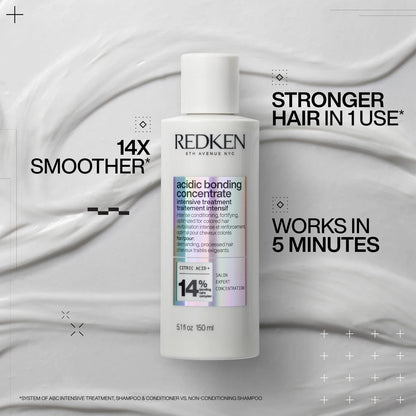 Redken hair treatment bottle with text on a gray background