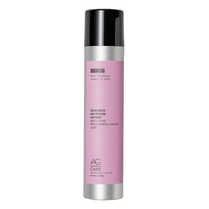 Pink hair product bottle with black cap on a white background