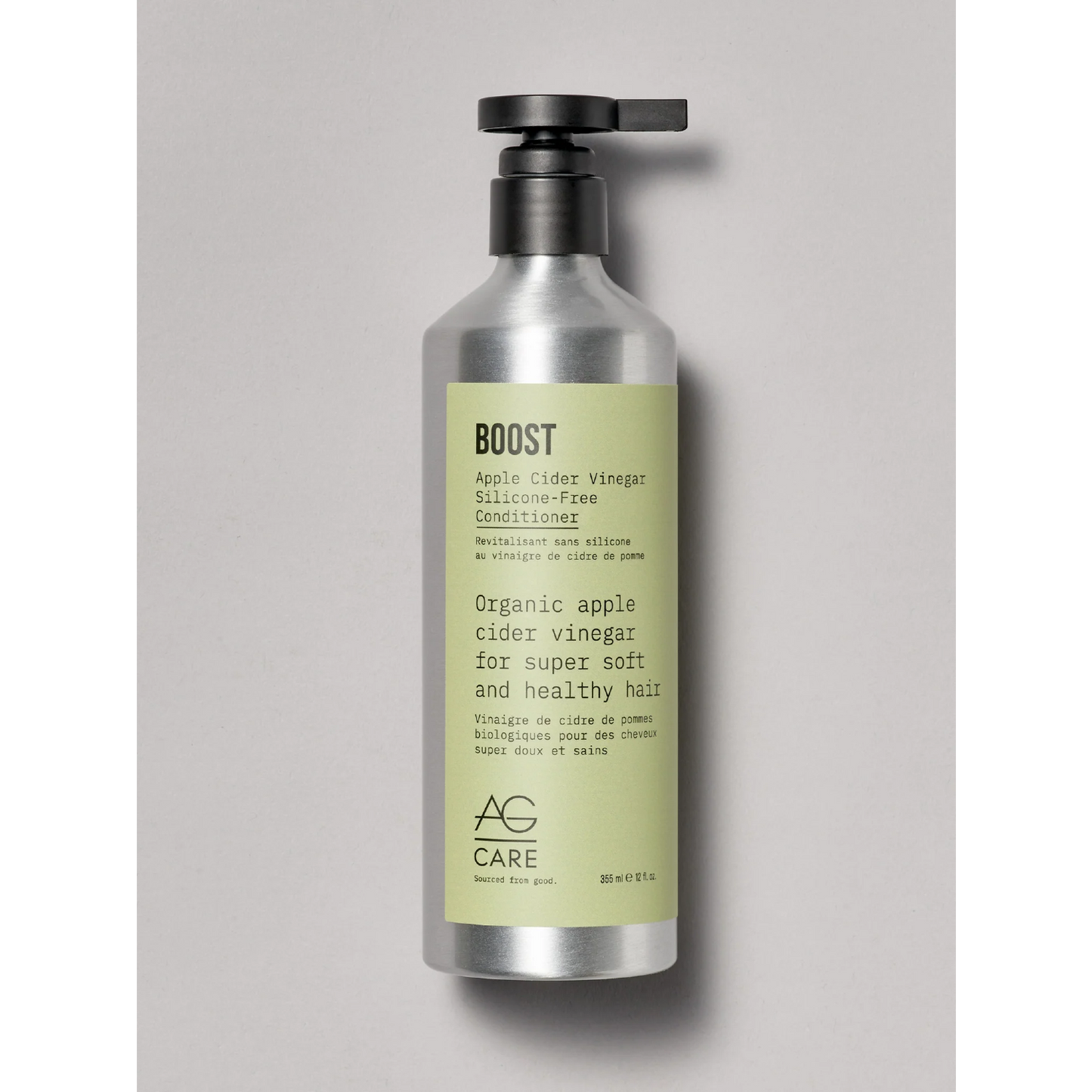 Bottle of AG Care Boost conditioner on a gray background