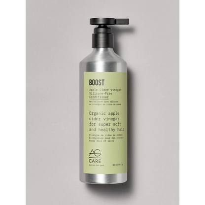 Bottle of AG Care Boost conditioner on a gray background