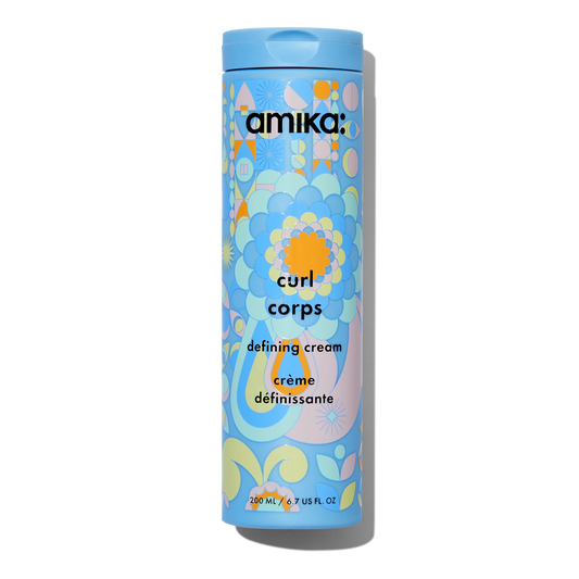 Amika Curl Corps defining cream container with colorful design on a white background
