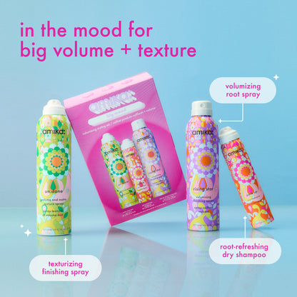 Amika hair care products with colorful packaging on a blue background