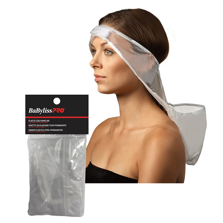 Woman wearing a plastic cold wave bib with BabylissPro packaging in the foreground.