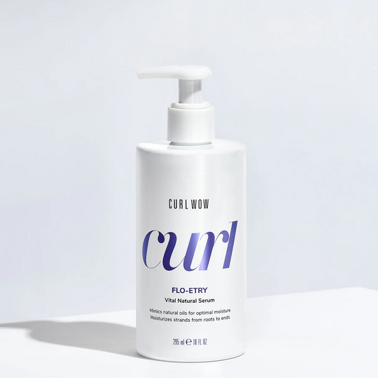 White bottle of Curl Wow Flo-Etry serum on a light gray background