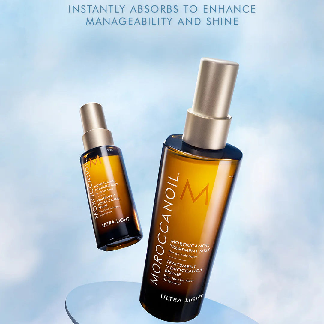 Moroccanoil Ultra-Light dry oil spray bottles on a light blue background