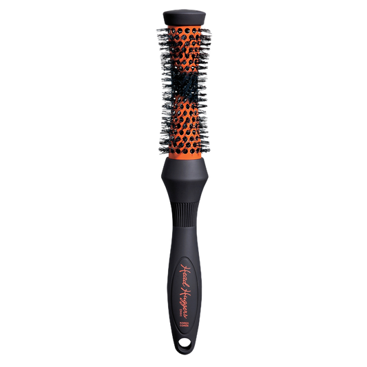 Round hairbrush with black and orange bristle pattern on a white background
