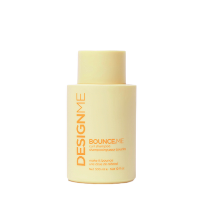 Yellow bottle of DesignMe hair product on a white background