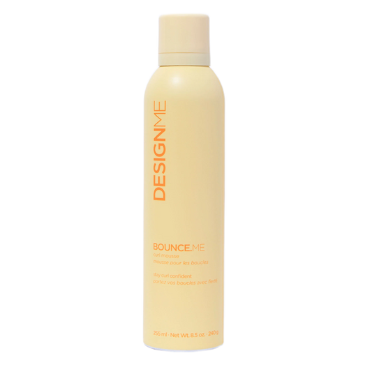 Yellow bottle of Design.Me hair product on a white background